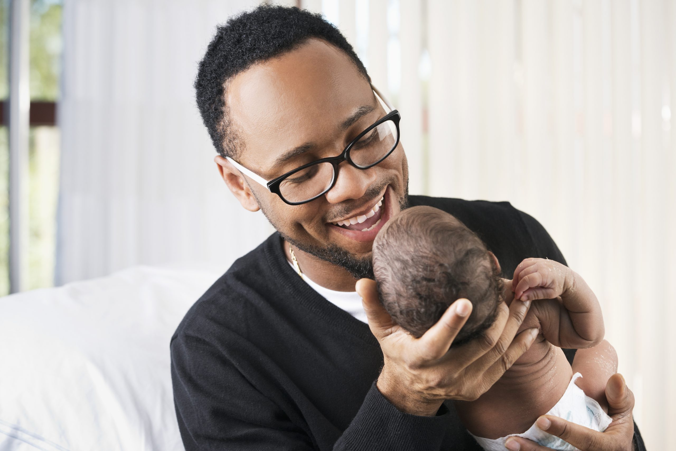 man in glasses holding child